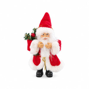 A plush Santa Claus figurine wearing a red and white suit with black boots, holding a green pine sprig with a red ornament, photographed against a plain white background.