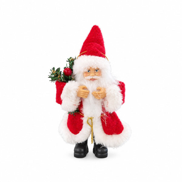 A plush Santa Claus figurine wearing a red and white suit with black boots, holding a green pine sprig with a red ornament, photographed against a plain white background.