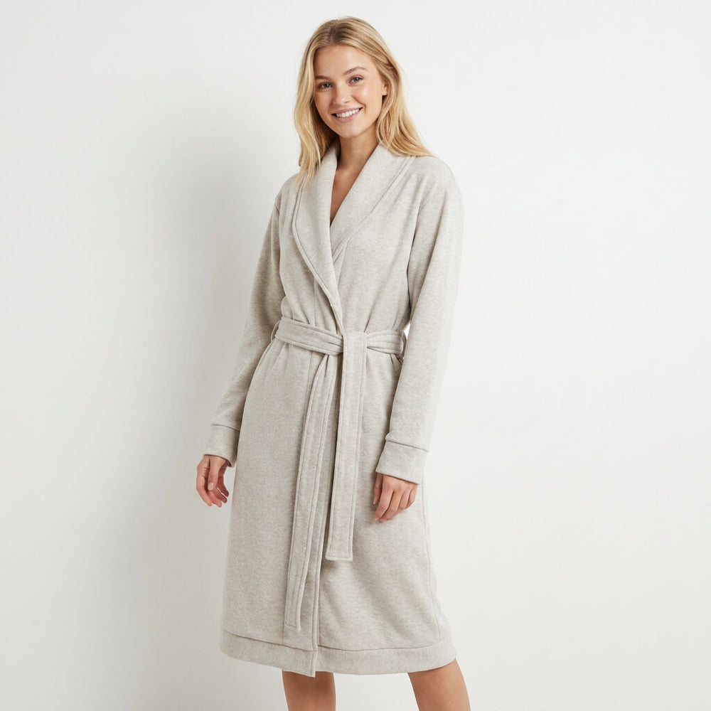 Woman wearing a beige robe against a white background