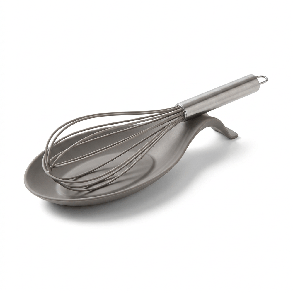 Kitchen counter with mixing bowl, whisk, and ingredients in a home kitchen setting