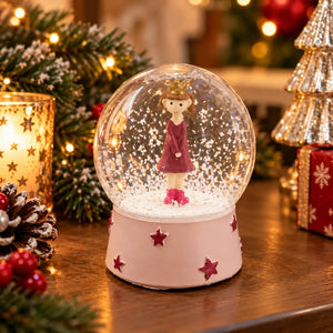 Migros girl snow globe displayed in a festive Christmas setting
