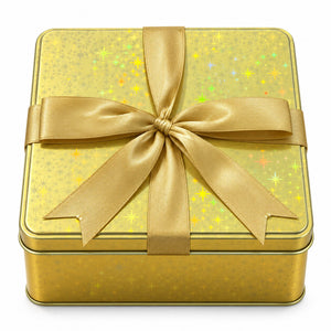 A square gold gift box with a sparkling star pattern on the lid, tied with a wide gold satin ribbon in a large bow, shown on a white background.