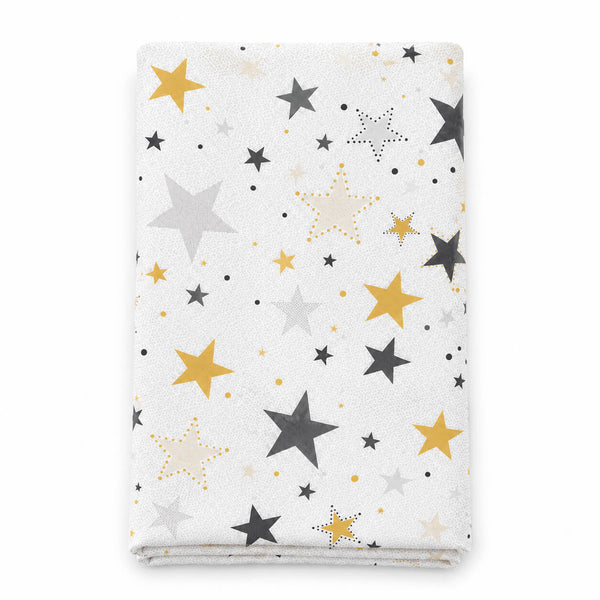 A folded white blanket or baby wrap featuring a scattered star pattern in mustard yellow, light gray, dark charcoal, and cream, set against a plain white background.