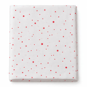 A folded white sheet or mattress protector featuring a scattered red star and dot pattern, shown against a plain white background.