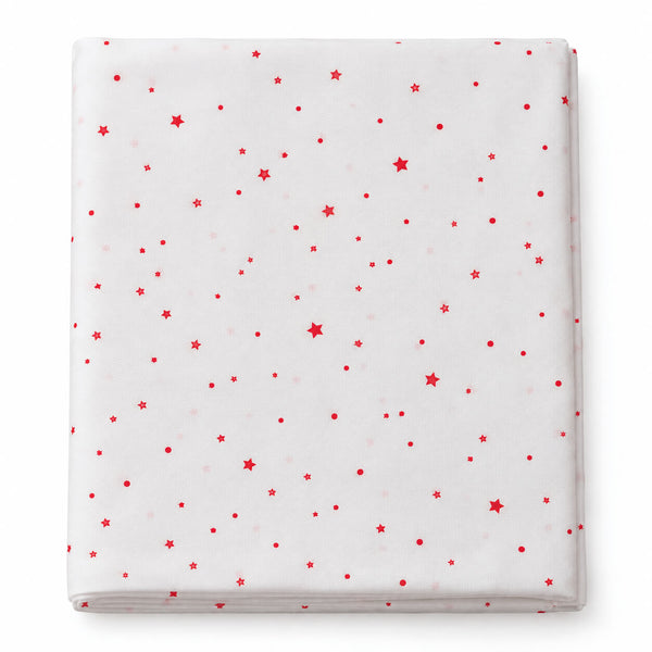 A folded white sheet or mattress protector featuring a scattered red star and dot pattern, shown against a plain white background.