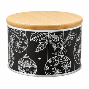A round metal canister with a light natural wood lid and a black body printed with white Christmas ornament and holly leaf illustrations, shown on a white background.