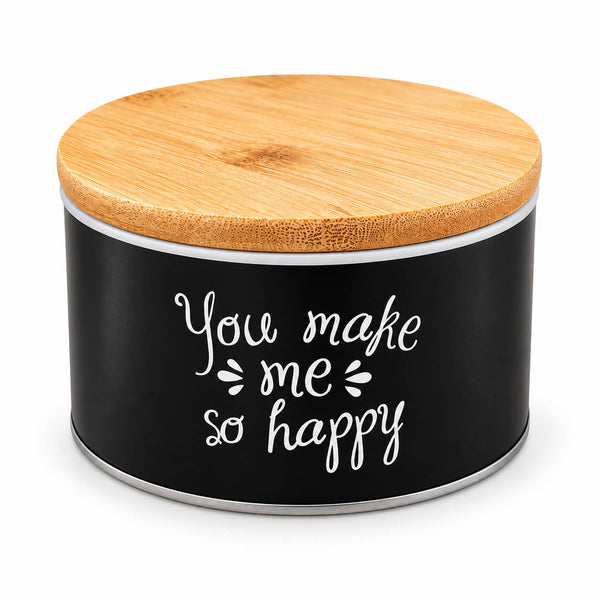 A cylindrical black storage jar with a light natural wood bamboo lid and white script text reading 'You make me so happy' on the front, shown on a clean white background.
