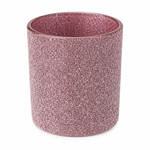 A cylindrical glittery cup or candle holder in a dusty rose pink color, shown on a plain white background.
