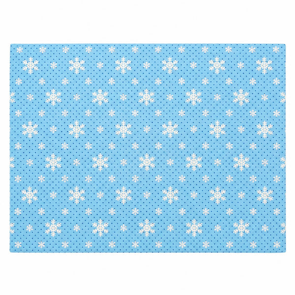 A rectangular blue fabric item, likely a placemat or mat, featuring a repeating pattern of white snowflakes and small white dots on a light blue background.