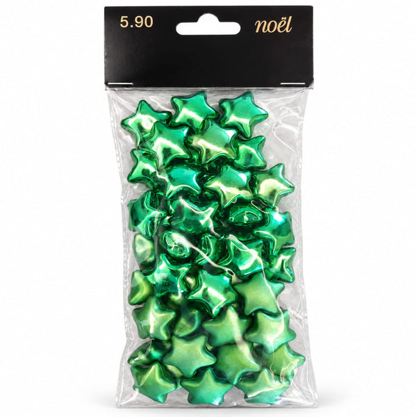 Pack of green metallic star-shaped confetti or ornaments in a clear plastic bag with a black header card labeled '5.90 noël'.