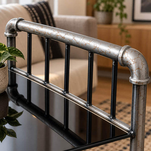 Industrial-style metal bed frame with distressed silver and black pipes and vertical bars, shown in a modern living room setting.