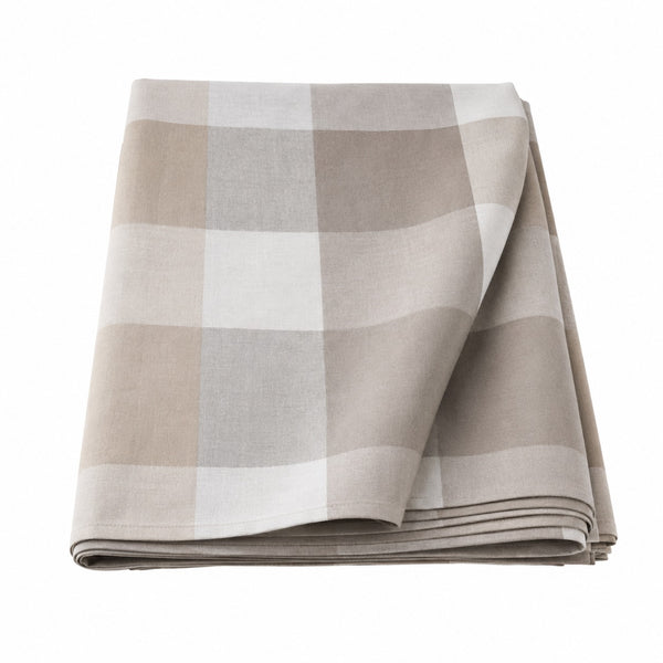 A folded checkered fabric napkin or table linen in neutral tones of beige, taupe, and off-white, shown on a solid white background.