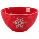 A red ceramic bowl with a ribbed exterior, featuring a silver snowflake and holly leaf design on the front, set against a plain white background.