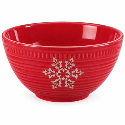 A red ceramic bowl with a ribbed exterior, featuring a silver snowflake and holly leaf design on the front, set against a plain white background.