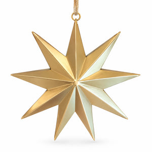 A faceted eight-pointed star Christmas ornament in polished gold, suspended by a thin gold cord against a clean white background.