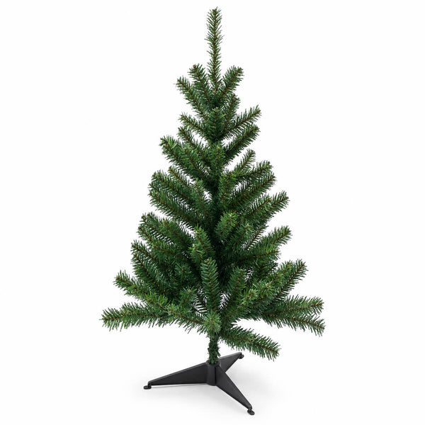 An artificial Christmas tree with dense green needles on a black metal tripod stand, photographed against a solid white background.