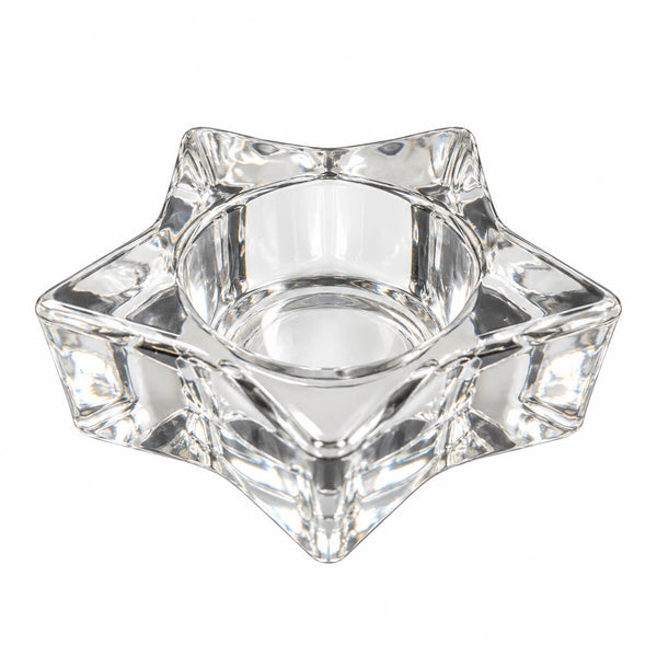 A clear crystal star-shaped candle holder with a central well, photographed on a solid white background.