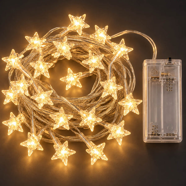 Warm white star-shaped LED fairy string lights coiled on a dark background, shown with a clear battery compartment containing two batteries.