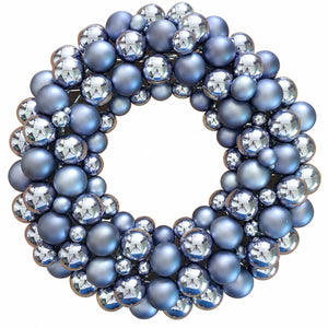 A decorative wreath made of layered blue and silver glass beads and faceted crystal-like spheres on a plain white background.