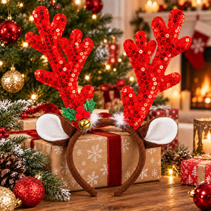 A festive Christmas reindeer antler headband with red sequined antlers, white faux fur ears, and brown faux fur trim, displayed on a wrapped gift box in a decorated holiday setting.