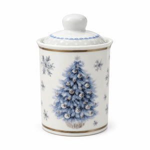 A white porcelain lidded jar decorated with a blue winter tree, silver ornaments, and blue snowflakes, accented with gold bands.