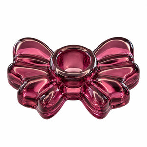 A translucent pink glass bowl with a balloon-bow design, photographed on a solid white background.