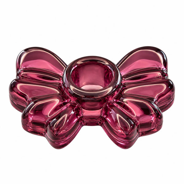 A translucent pink glass bowl with a balloon-bow design, photographed on a solid white background.