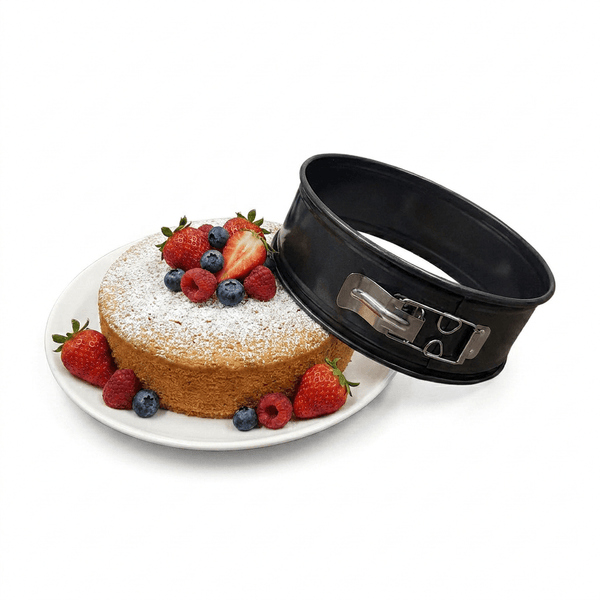 Cake with berries and a black cake lifter on a white background