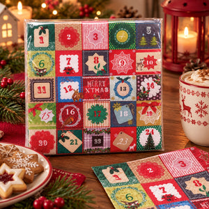 A Christmas advent calendar in clear plastic packaging, displayed on a wooden table with holiday decorations including a mug of hot cocoa, cookies, and candles.