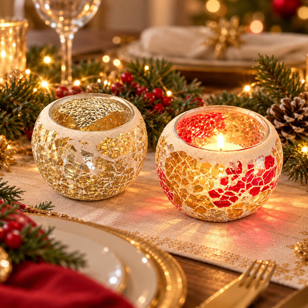 Two round mosaic candle holders on a decorated holiday table runner, one with gold leaf-like tiles and one with red and gold tiles, each holding a glowing candle.