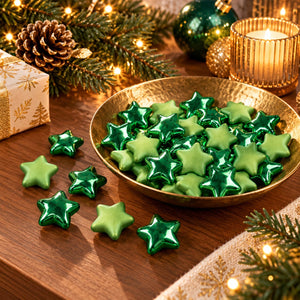 A pile of small metallic star-shaped beads in shades of green