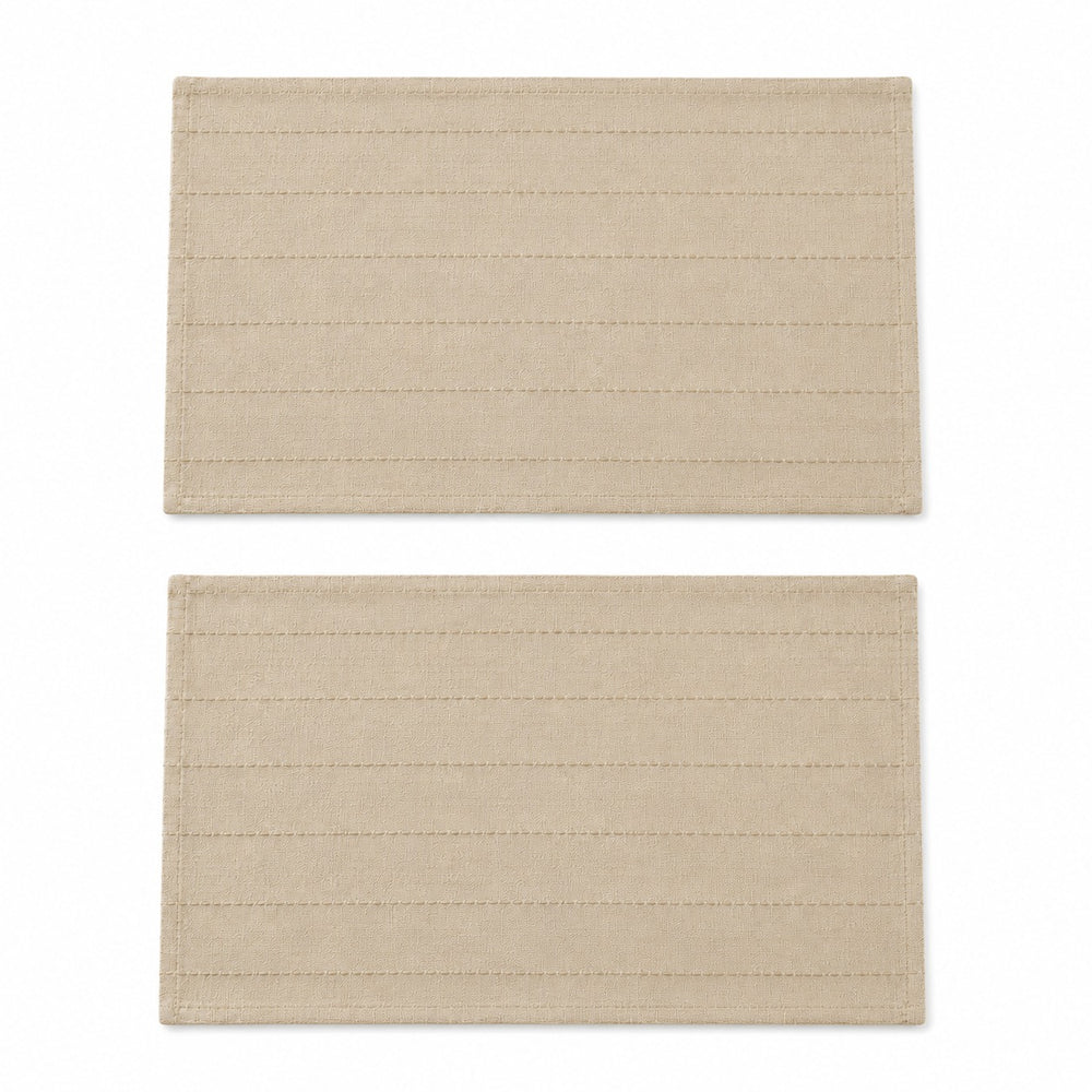 ALT Text
Set of 2 beige woven placemats styled on a wooden outdoor dining table with neutral dinnerware, cutlery, glasses, and decorative greenery in a sunny patio setting.