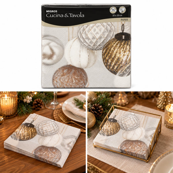 Migros Cucina e Tavola paper napkins with a printed design of metallic gold and white Christmas ornaments, shown in its retail packaging and styled on a wooden table with candles and tableware.