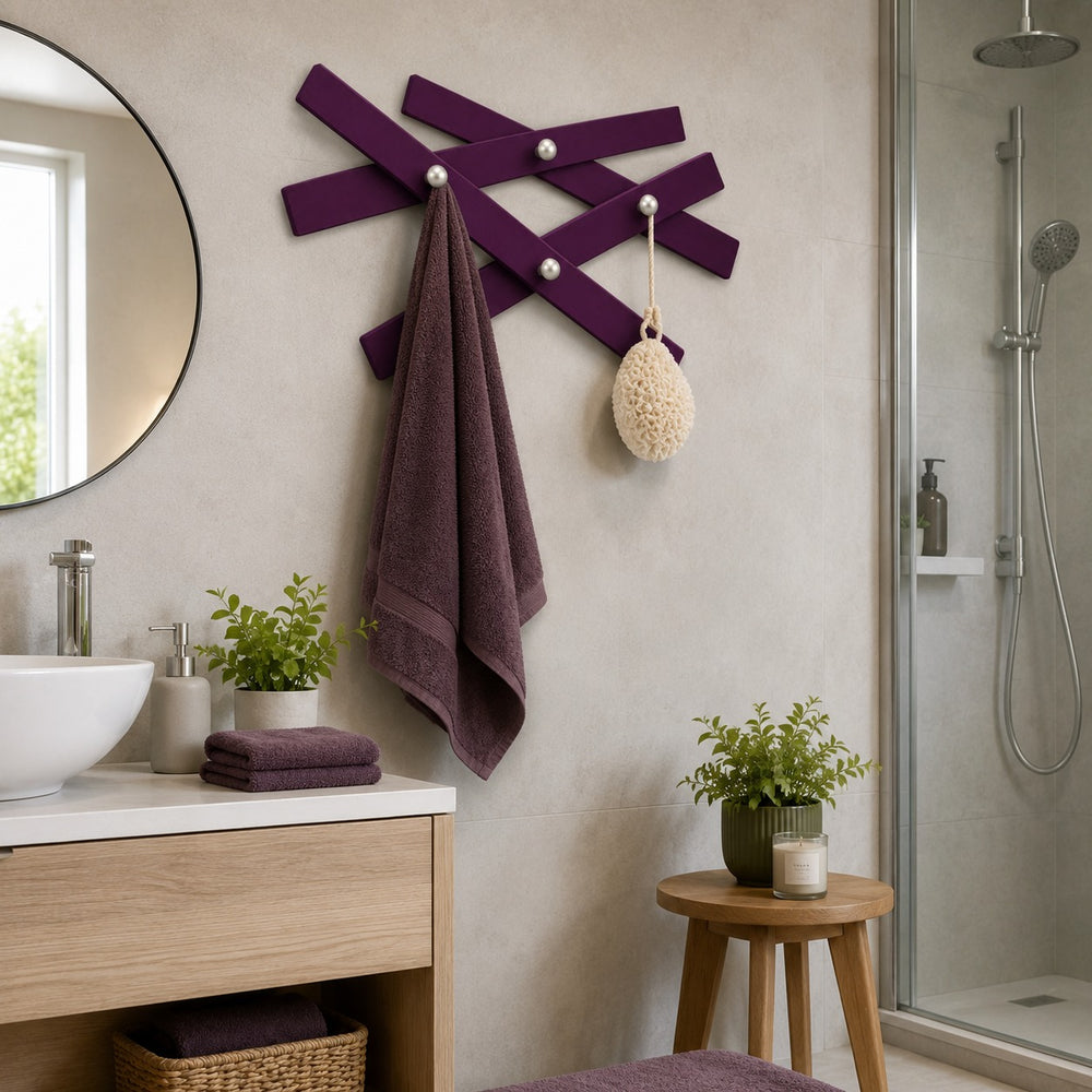 Mikado wooden wall coat rack with 4 brushed silver hooks. Decorative crossed-slat design available in Blackberry and Pistachio Green. Ideal for entryways, bedrooms, hallways, and offices.