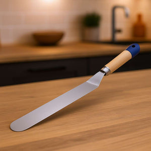 Spatula with wooden handle on a wooden surface