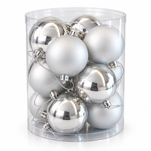 A clear cylindrical plastic container filled with multiple silver Christmas ornaments, including both matte frosted silver and shiny metallic silver baubles, on a white background.