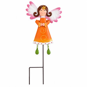 A decorative angel garden stake featuring a smiling angel figure with brown hair, pink and white wings, an orange dress, and green legs, mounted on a black metal stake against a plain white background.