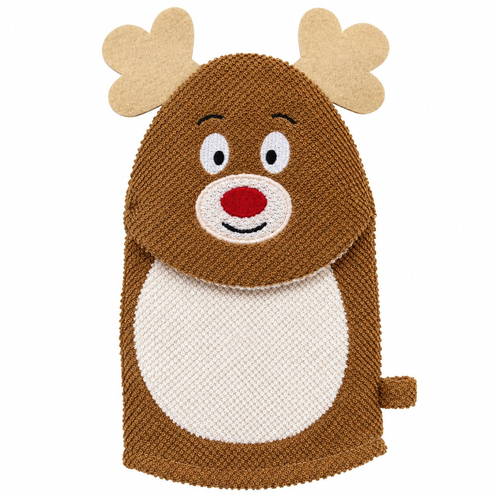 A person wearing a cream knit sweater uses a brown and white knitted reindeer-shaped oven mitt to pull a baking sheet of chocolate chip cookies out of a lit oven in a cozy kitchen setting.