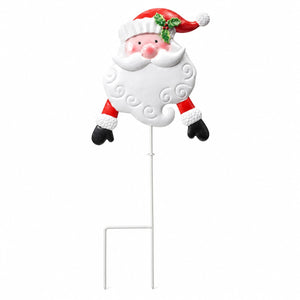 A decorative Santa Claus yard stake featuring a smiling Santa head and upper body with a white beard, red hat with green holly, and red-and-white clothing, mounted on a white metal stake against a plain white background.