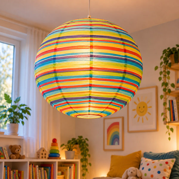 A colorful striped spherical pendant lamp glowing with warm light, hanging in a cozy child's room with shelves, plants, and framed wall art.