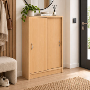 A light natural wood sliding cabinet with two doors and silver handles, styled in a modern entryway next to a slatted wood wall, bench, and door.