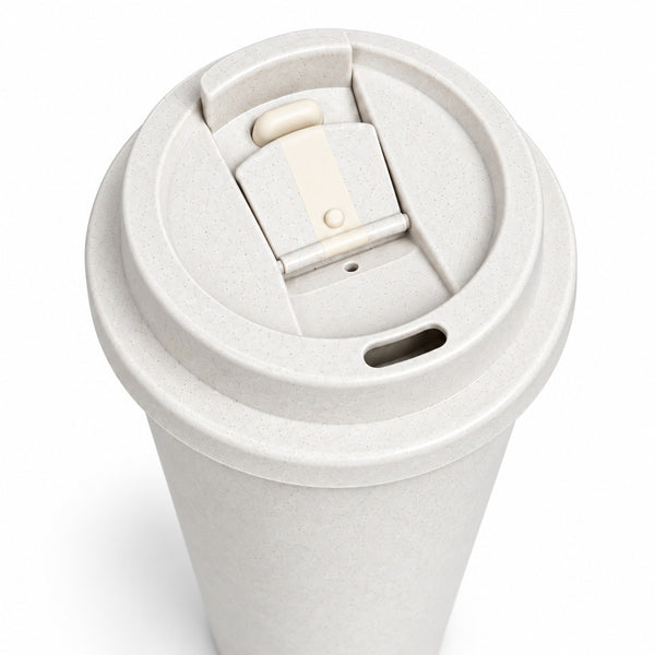 A close-up of a reusable paper coffee cup with a light beige textured lid featuring a flip-up straw cover and a small drainage hole, shown on a white background.