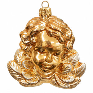 A shiny gold Christmas ornament shaped like a cherub's face with curly hair and a hanging loop at the top, shown on a plain white background.