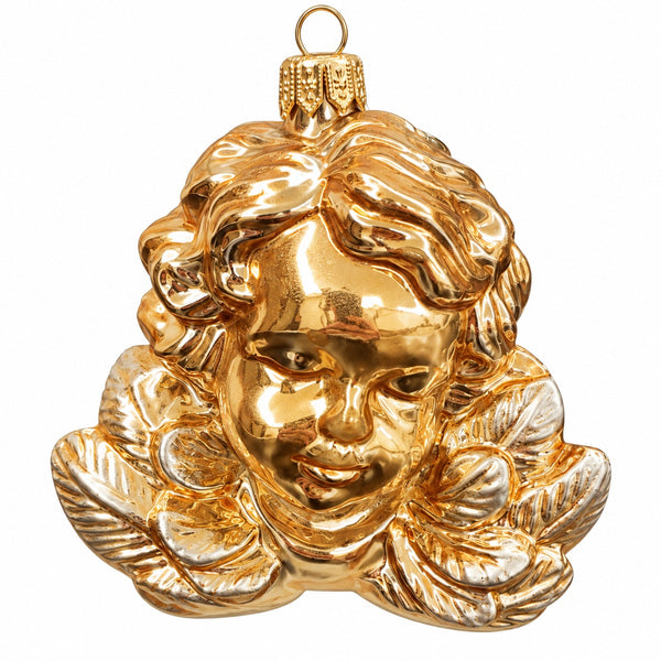 A shiny gold Christmas ornament shaped like a cherub's face with curly hair and a hanging loop at the top, shown on a plain white background.