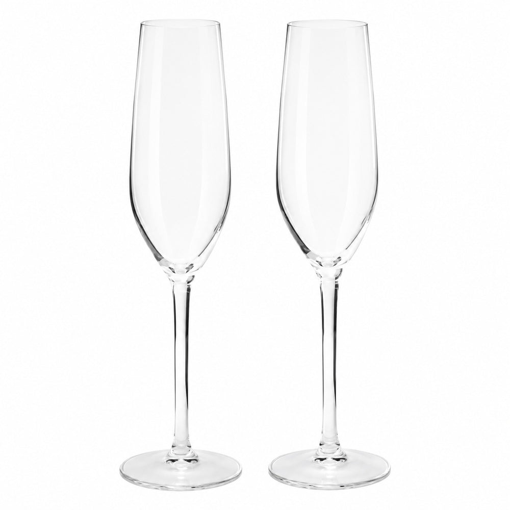 L'Atelier du Vin set of two champagne flutes filled with sparkling wine, elegantly displayed on a luxury welcome drink table with fresh white flowers, creating a sophisticated reception setting.