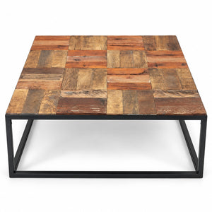 A square coffee table with a rustic patchwork wood top made of various brown and beige wooden planks, supported by a black metal frame base, shown on a white background.