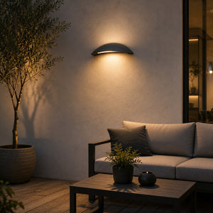 Massive Pori outdoor wall light providing warm ambient lighting above a modern patio seating area.