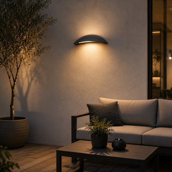 Massive Pori outdoor wall light providing warm ambient lighting above a modern patio seating area.