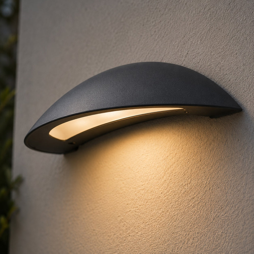 Massive Pori LED wall light illuminating a contemporary home entrance at night.