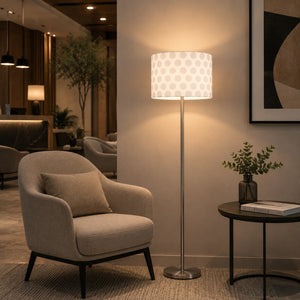 Micasa modern floor lamp with brushed nickel finish and white patterned fabric shade illuminating a contemporary hotel lounge with elegant ambient lighting.
